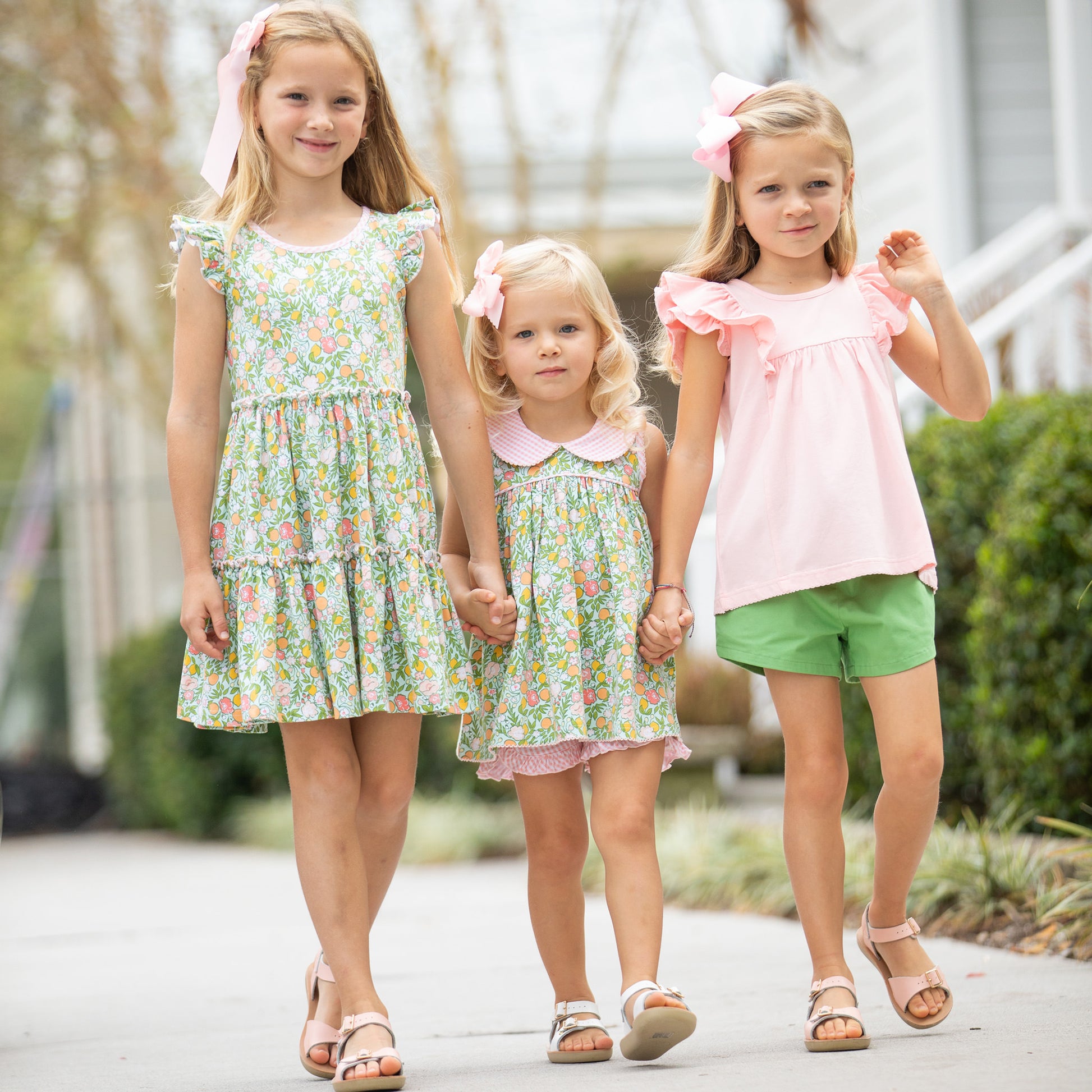 three little girls walking down the sidewalk and one is wearing Tennis Club Ruffle Shorts