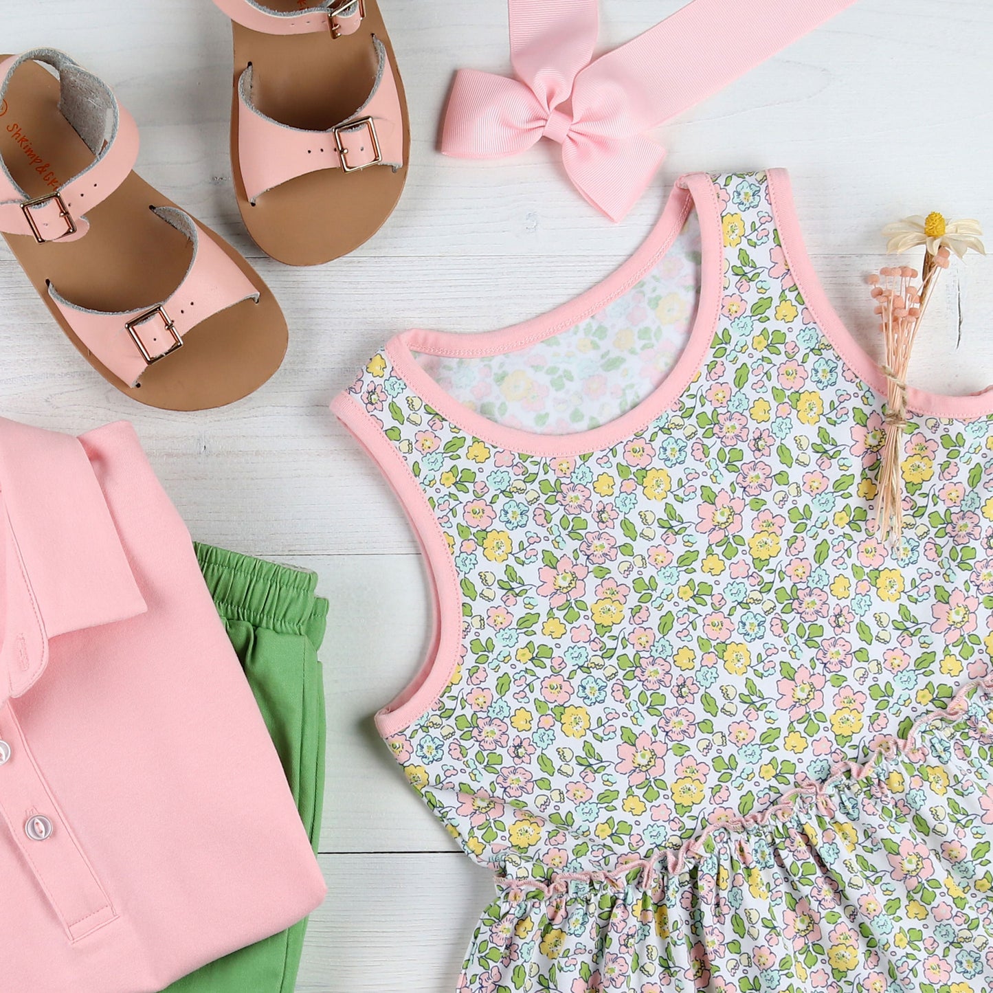 flatlay of Tybee Floral Tier Dress, pink shirt, green shorts, pink sandals