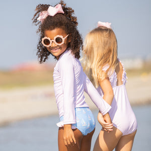 little girl wearing Preppy Pink Stripe Rash Guard and holding hands with another little girl