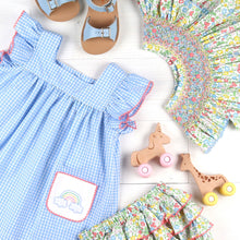 Load image into Gallery viewer, Sunny Rainbow Embroidered Set flatlay with a dress, bloomers, sandals and wooden unicorn and giraffe toys