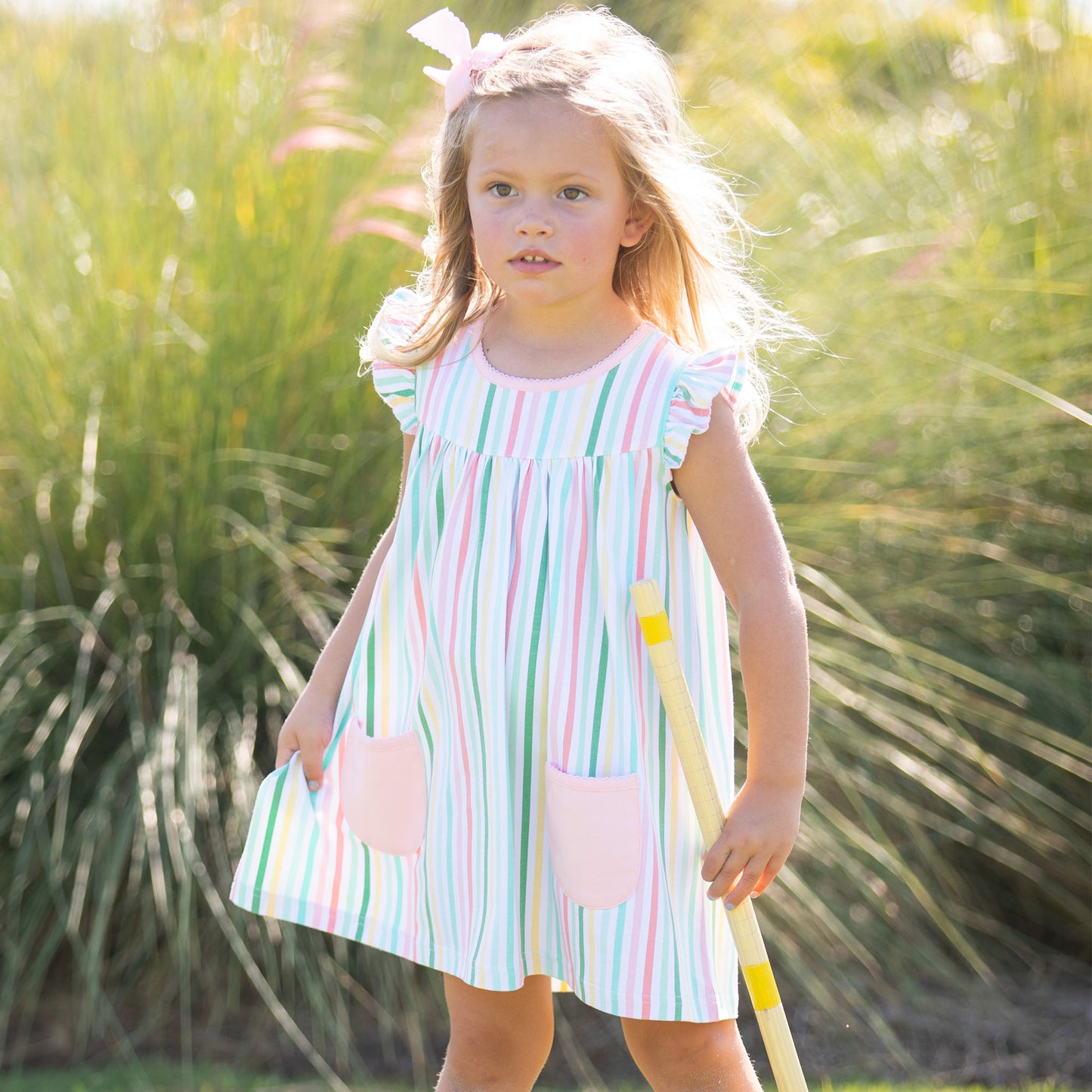 little girl wearing Beach Club Stripe Flutter Play Dress