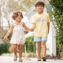 Load image into Gallery viewer, one little boy in Yacht Club Stripe Smocked Bubble holding his brothers hand walking down sidewalk
