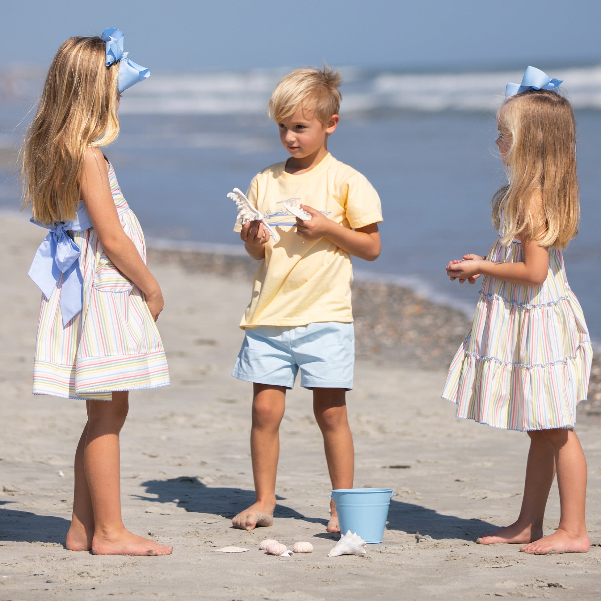 a little boy and 2 little girls on the beach - one little girl wearing Yacht Club Stripe Bow Back Dress