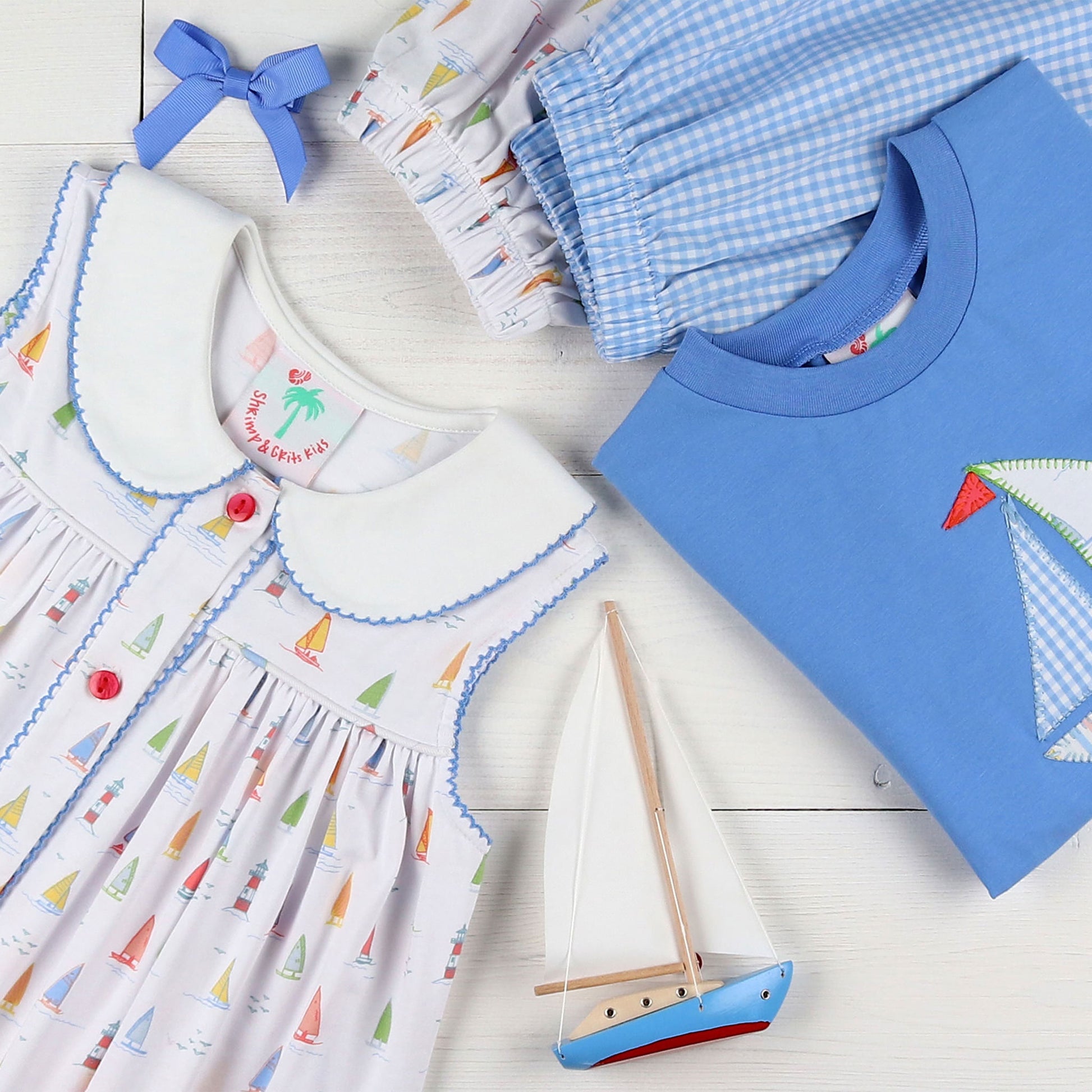 flatlay of Blue Check Knit Shorts, blue bows and shirt