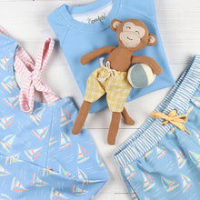Load image into Gallery viewer, flatlay of bathing suits and a monkey stuffed animal