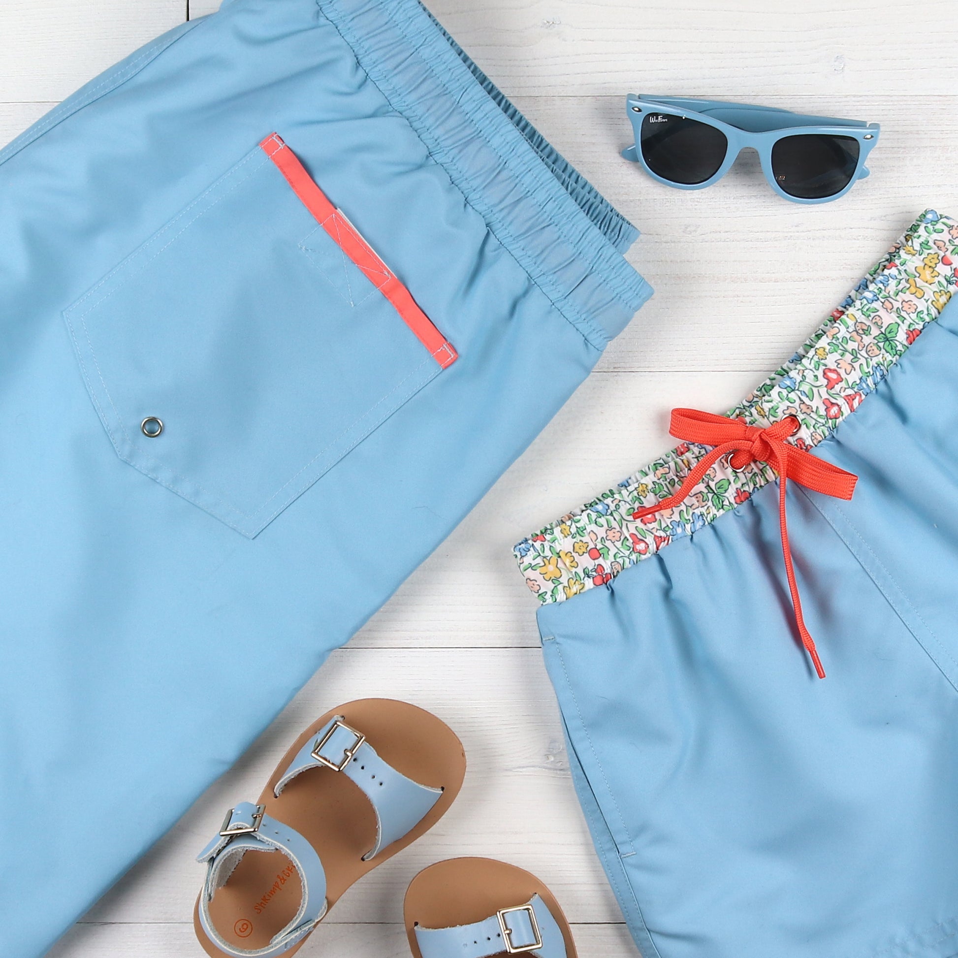 flaylay of Skye Boardies, blue sandals and blue sunglasses