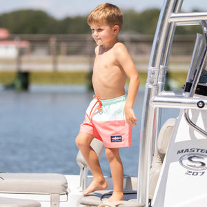 little boy wearing Sorbet Swim Boardies on the boat