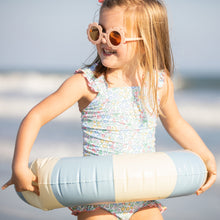 Load image into Gallery viewer, little girl in sunglass and blue floaty at the beach