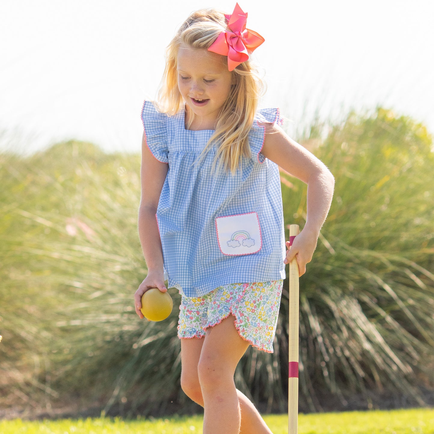 little girl playing croquet wearing Sunny Rainbow Embroidered Set