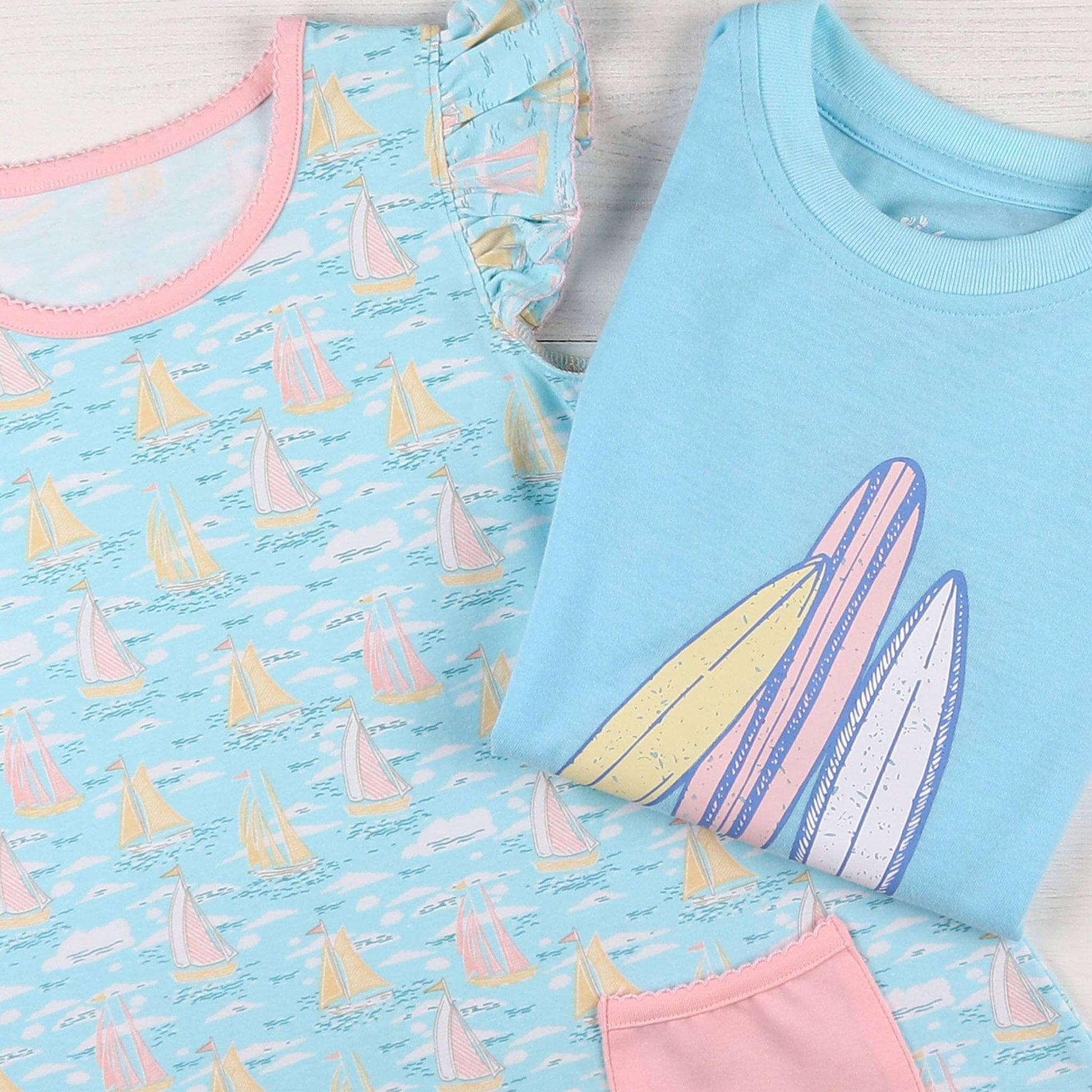 flatlay of Surfs Up Graphic Tee and a dress
