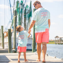 Load image into Gallery viewer, dad wearing Sorbet Swim Men&#39;s Boardshorts holding hands with his son on the boardwalk