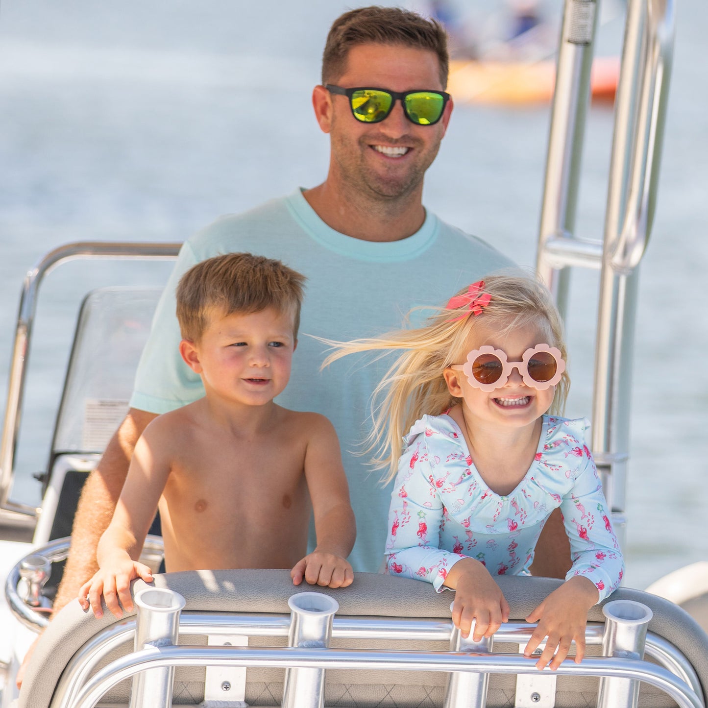 dad, daughter and son in the boat smiling