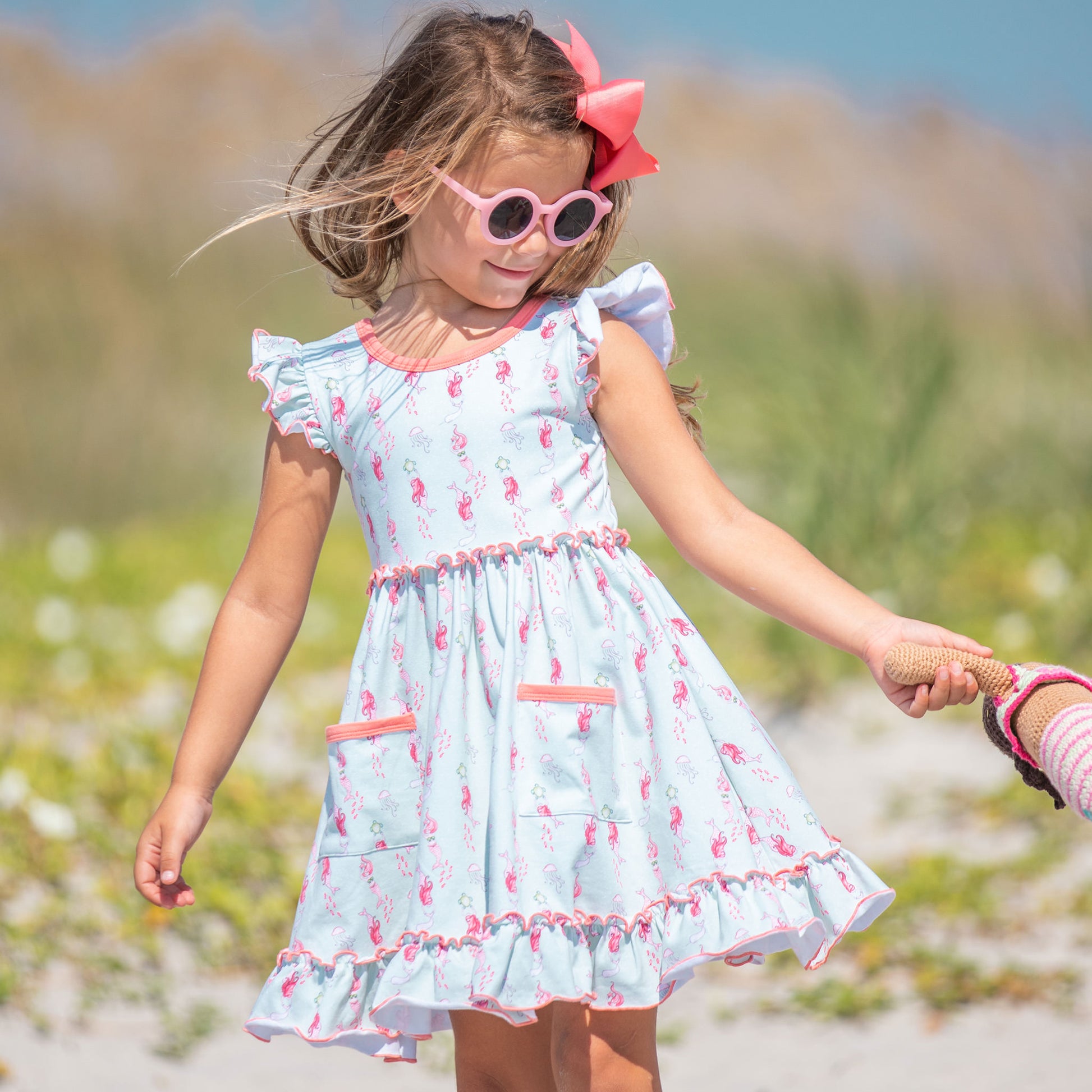 little girl smiling and playing at the beach