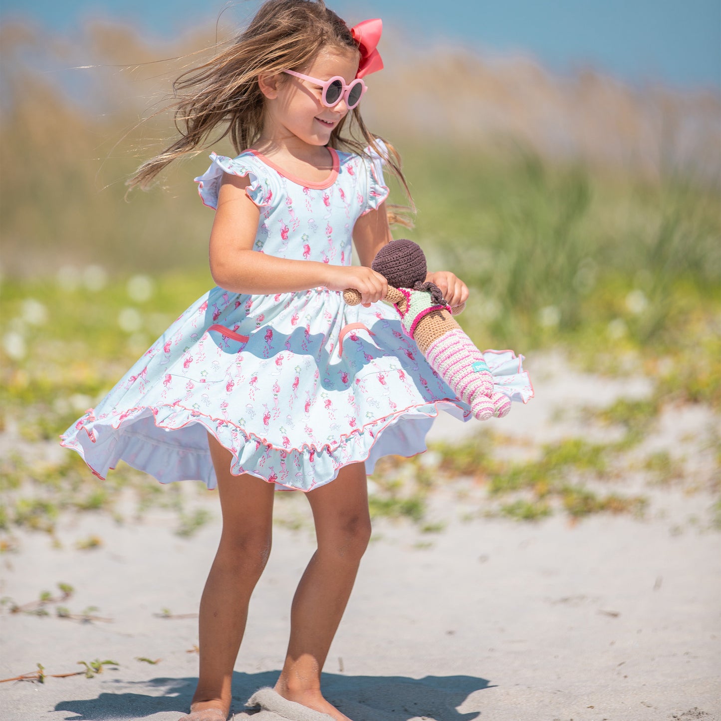 little girl wearing Under the Sea Twirl Dress at the beach